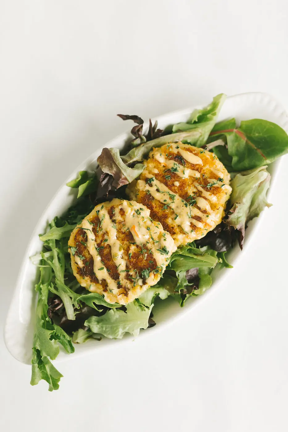 Crab cakes over greens
